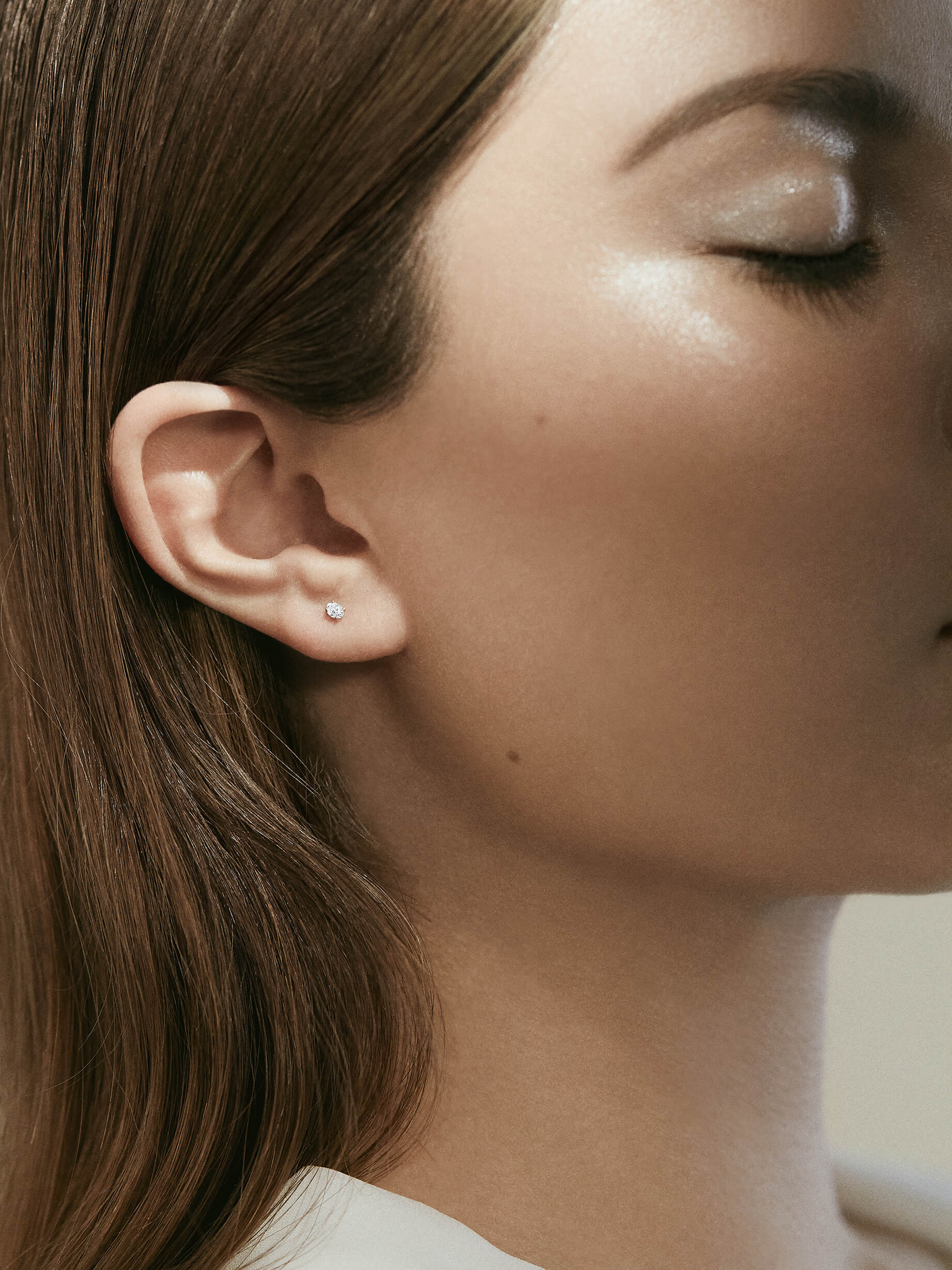 Brilliant oval cut diamond stud set in 18k yellow or white gold sold individually so you can mix, match, or stack with other mini studs from our Carbon Earring Collection.